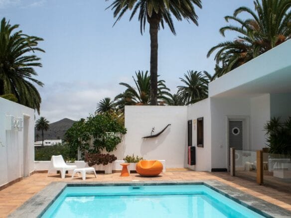 a swimming pool with palm trees